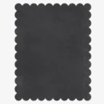 Top down view of the Aether Dior dark charcoal grey hand tufted wool rug on a white background showing the rectangular shape and scalloped edges.