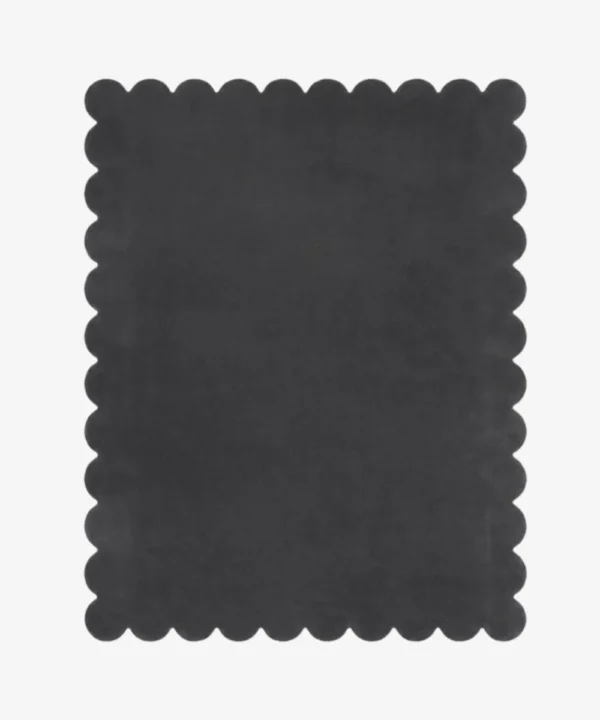 Top down view of the Aether Dior dark charcoal grey hand tufted wool rug on a white background showing the rectangular shape and scalloped edges.