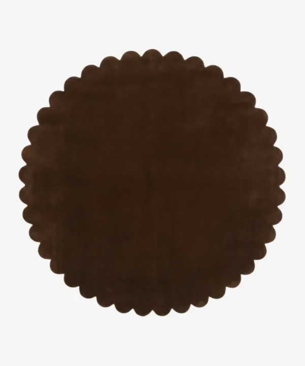 Top down view of the circular Cocoa Crest dark brown hand tufted wool rug on a white background showing the scalloped border.