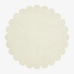 Top down view of the circular Cream Halo off white hand tufted wool rug on a white background showing the soft scalloped border.