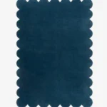 Top down view of the Deep Marine blue hand tufted wool rug on a white background showing the rectangular shape and scalloped edges.