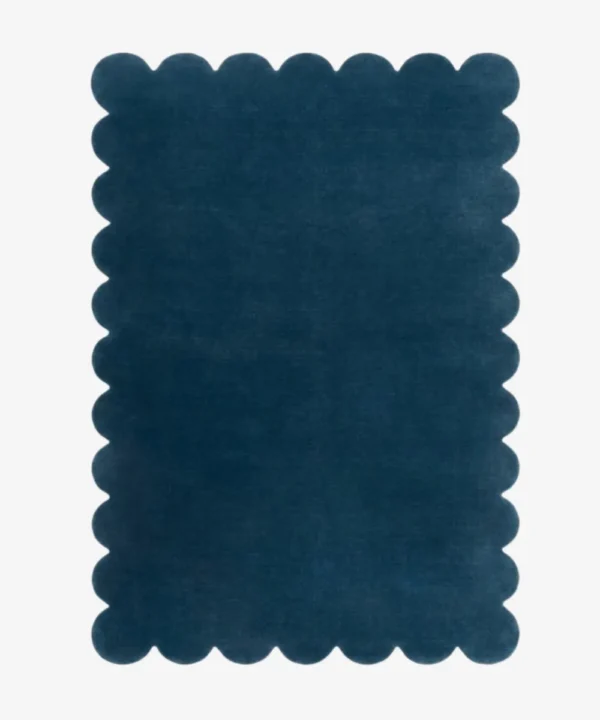 Top down view of the Deep Marine blue hand tufted wool rug on a white background showing the rectangular shape and scalloped edges.