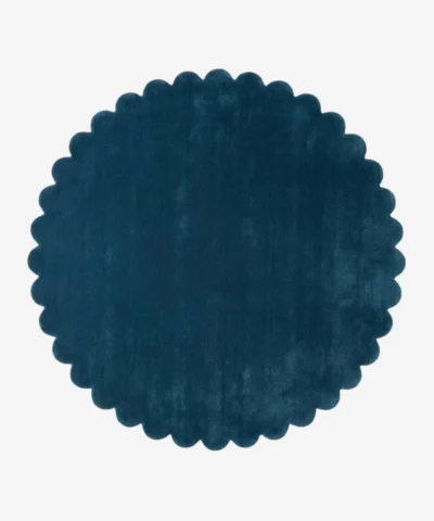 Top down flat lay of the Deepstone round wool rug showing the rich navy blue color and scalloped border.