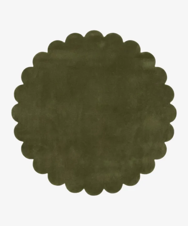 Top down view of the circular Forest Mirage green hand tufted wool rug on a white background showing the scalloped border.