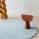 Close up angled shot of the Ice Whisper rug highlighting the plush baby blue wool pile and tufted craftsmanship.