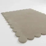 Close up angle of the Moonstone rug showing the dense wool texture and precision cut scalloped edges.