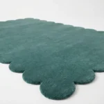 Close up angle showing the plush wool texture and high quality cut pile of the Ocean Mist rug edge.