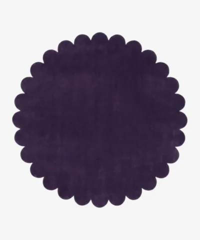 Top down view of the Plum Eclipse circular rug showing the deep violet wool color and scalloped edges.