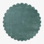 Top down flat lay view of the Sagewave circular rug showing the soft teal green wool color and scalloped border.