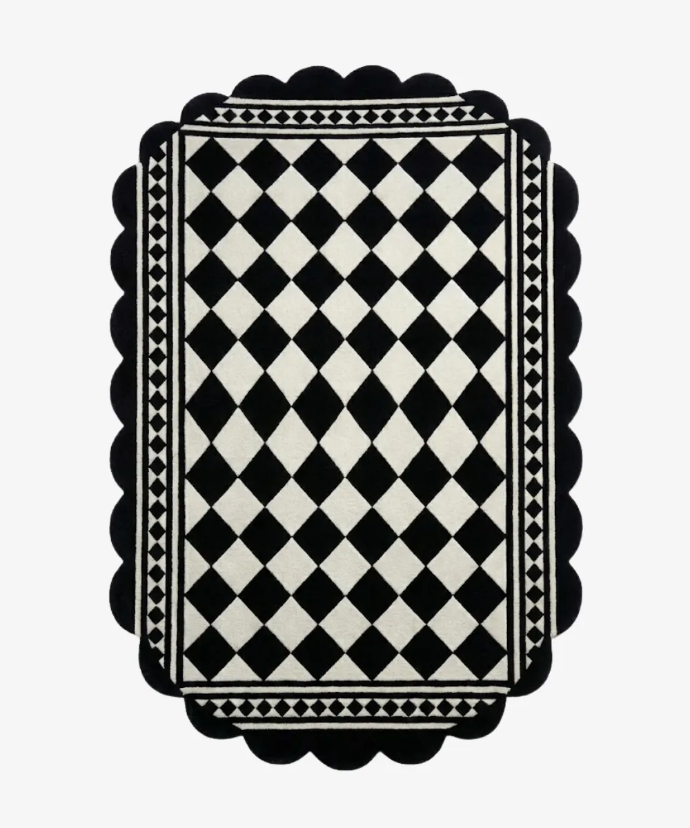 A black and white diamond check rug with scalloped borders, used to browse Large Area Rugs or Geometric shapes.