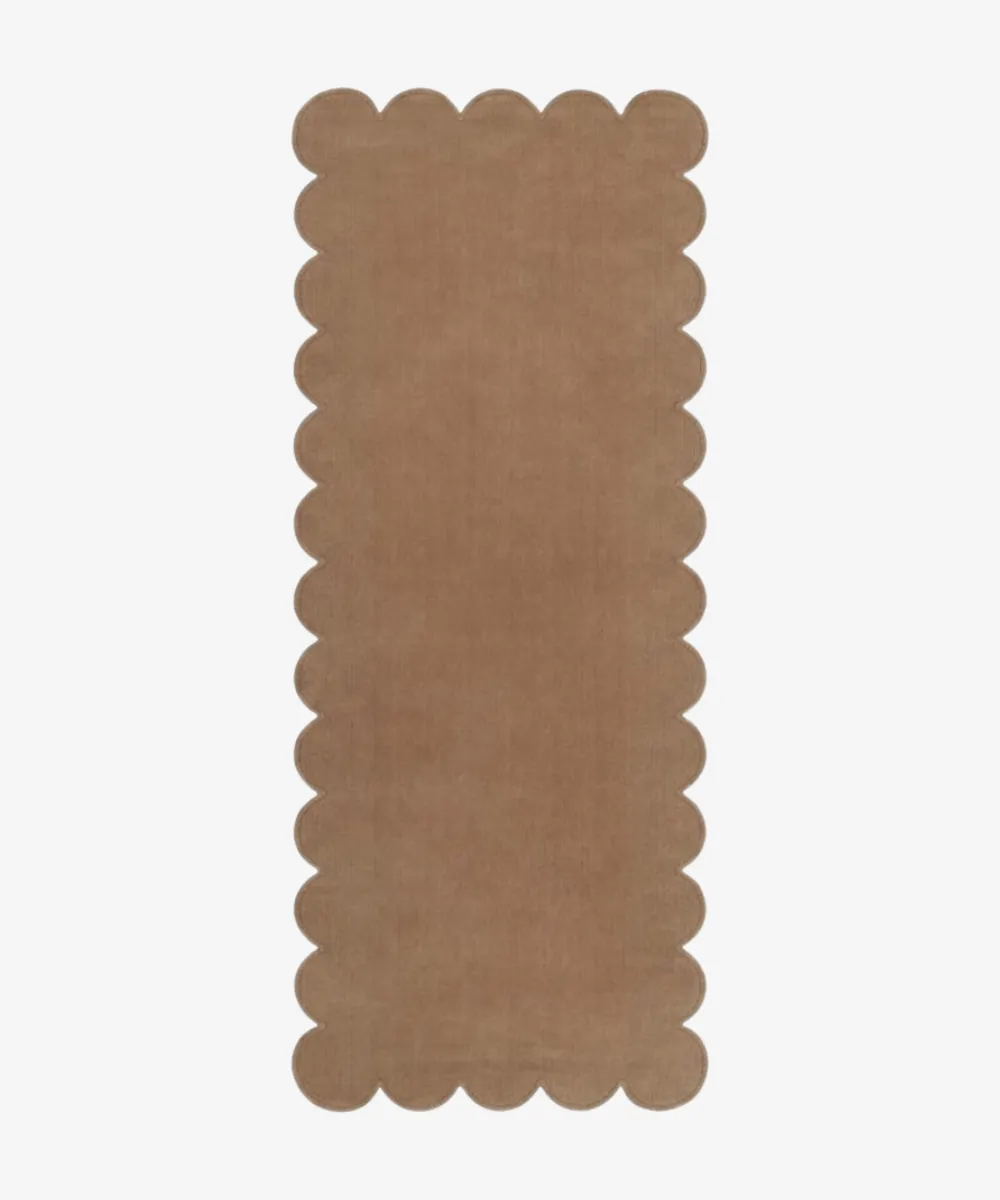 A long light brown runner rug with decorative edges, representing the Hallway Runners category.