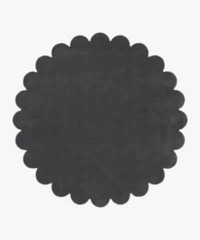 Top down flat lay view of the Slate Cloud round rug showing the dark charcoal grey wool color and scalloped border.