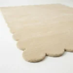 Close up angle showing the plush wool texture and high quality cut pile of the Vanilla Crest rug edge