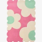 Top down view of the Blush Petalia rug featuring large abstract cream and mint green flower motifs on a vibrant pink wool background with scalloped edges.