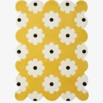 A retro inspired yellow area rug with a playful pop art flower design and decorative wavy scalloped borders.