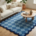 The Coastal Current rug styled in a bright living space with neutral furniture, showing how the blue geometric pattern adds a fresh, airy vibe to the room.