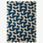 Top down flat lay of the Coastal Mosaic hand tufted rug showing the full repeating pattern of alternating blue and cream geometric shapes.