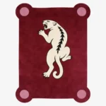 Top down view of the Crimson Prowl rug featuring a deep maroon wool background with a stylized white panther climbing design and pink circular corner accents.