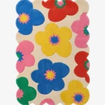 A vibrant and fun multicolor wool area rug with scalloped edges, perfect for adding a dopamine decor touch to a nursery or living space.