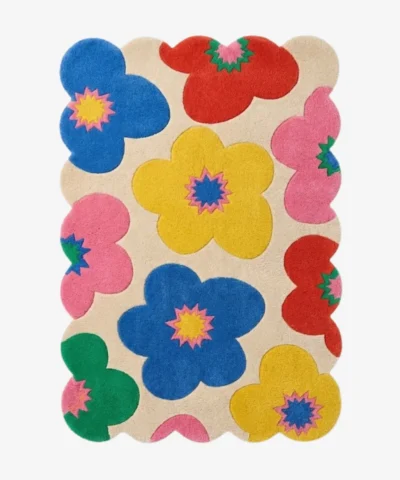 A vibrant and fun multicolor wool area rug with scalloped edges, perfect for adding a dopamine decor touch to a nursery or living space.