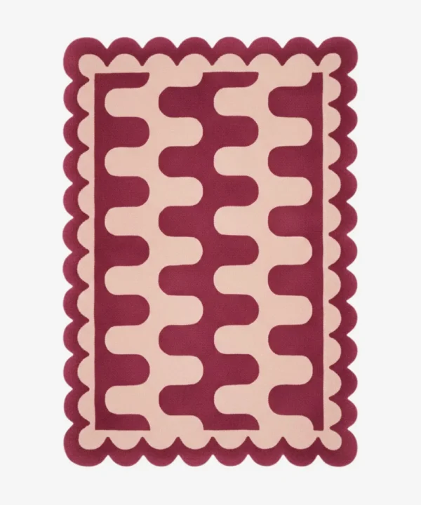 Top down view of the Garnet Loop rug featuring a rich maroon wool background with a bold cream wavy geometric pattern and custom scalloped edges.