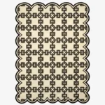 Top down view of the Heritage Lattice rug featuring a sophisticated cream wool background with an intricate dark brown interlocking geometric chain pattern and custom scalloped edges.