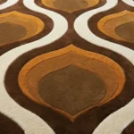 Close up texture shot of the Honeyed Waves area rug highlighting the dense plush hand tufted wool pile and the warm earth tone color palette.