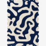 Top-down view of the Inked Dyed rug against a white background, featuring a bold, organic, maze-like abstract pattern in solid deep blue and cream, framed by a continuous scalloped border.
