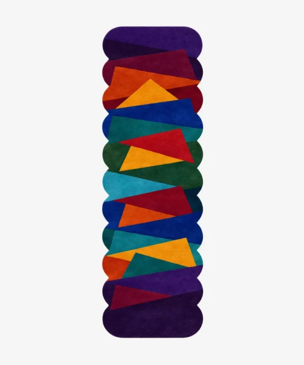 Top down view of the Jewel Shards runner rug on a white background, featuring a vibrant geometric pattern of overlapping angular shapes in deep jewel tones like purple, teal, and orange with scalloped edges.