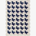 Top-down view of the Midnight Surge rug against a white background, featuring a repeating 3D geometric pattern of dark blue crosses with lavender shadows on a solid cream background, framed by a continuous cream scalloped border.