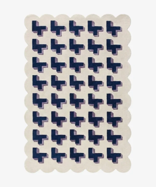 Top-down view of the Midnight Surge rug against a white background, featuring a repeating 3D geometric pattern of dark blue crosses with lavender shadows on a solid cream background, framed by a continuous cream scalloped border.