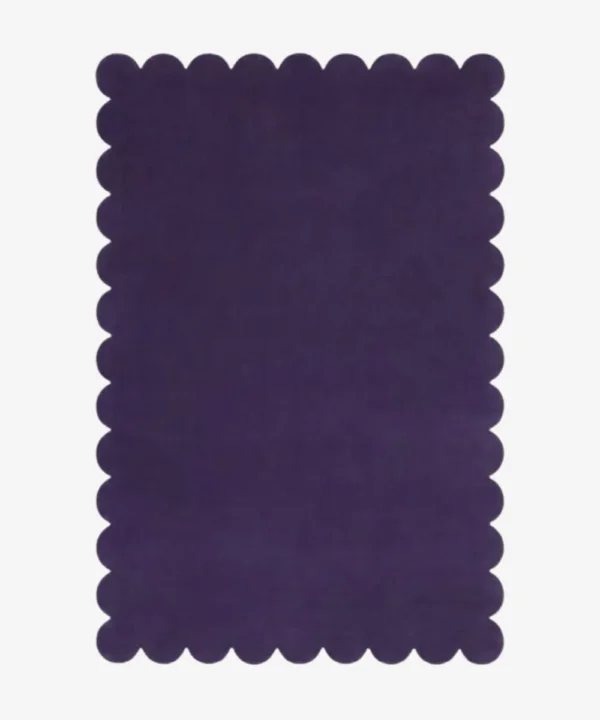Top down flat lay of the Nightberry rug featuring a rich deep purple color and decorative scalloped borders isolated on a white background.