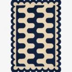 Top down view of the Obsidian Grid rug featuring a deep navy blue wool background with a bold cream wavy geometric pattern and custom scalloped edges.