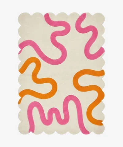 Top down view of the Peach Giggle rug featuring a soft cream background with playful abstract squiggly lines in bright pink and orange.