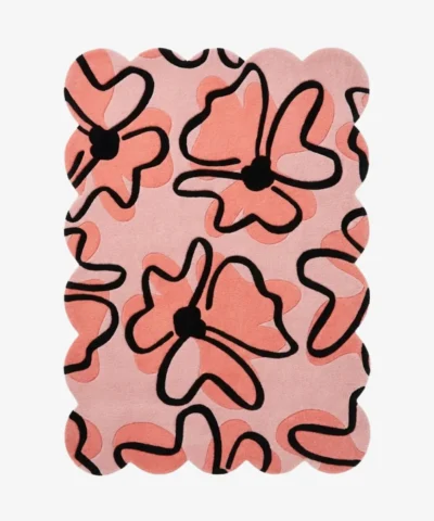 Top down view of the Peachy Sketch rug featuring a soft pink background with large abstract peach floral doodles outlined in bold black.