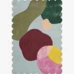 Top down view of the Pebble Parade rug against a white background, featuring large, organic, pebble-like abstract shapes in shades of olive green, dark green, deep burgundy, pink, yellow, and peach on a light blue background, framed by a continuous light blue scalloped border.