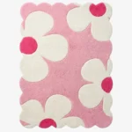 Top down view of the Petal Puff rug featuring a soft pink background with large white cloud like flower shapes and vibrant hot pink centers.