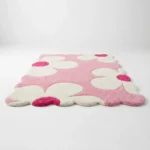Low angle perspective of the Petal Puff area rug highlighting the thick hand tufted wool pile and the cute wavy scalloped edges perfect for a nursery or bedroom.