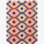 Top down view of the Petal Weave rug featuring a retro repeating floral pattern with pink flowers and blue wavy lines on a cream background.