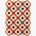 Full view of a modern retro style wool rug with scalloped edges showcasing a colorful blush pink and deep blue flower pattern perfect for adding a pop of color.