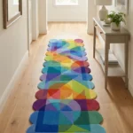 Eye level view of the Prism Cascade runner rug placed in a light-filled hallway with wooden floors, displaying a vibrant geometric pattern of overlapping triangles and circles in rainbow hues.