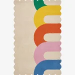 Top down view of the Rainbow Arcana rug featuring a soft cream background with colorful geometric rainbow arches in green yellow orange pink and blue.