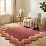 The Rose Whisper rug styled in a neutral living space, showing how the deep burgundy and soft pink tones add warmth and texture to the room.