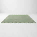 Low angle perspective of the Sage Rhythm rug highlighting the dense plush hand tufted wool pile and the linear carved details.