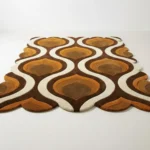 Low angle perspective of the Honeyed Waves rug showing the unique decorative scalloped border and the rhythmic geometric wave design.