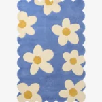 Top down view of the Sea Tonic rug featuring a fresh blue background with large white daisy motifs and yellow centers.