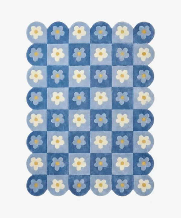 Top down view of the Sky Carousel rug featuring a playful checkerboard pattern in dark and light blue with white daisy flowers in every square.