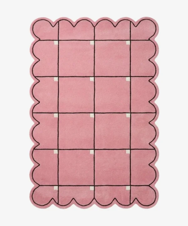 Top down view of the Soft Depth rug featuring a soft pink wool background with a delicate dark grid pattern accented by small white squares and custom scalloped edges.