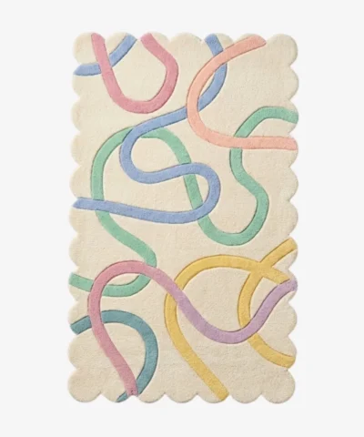 Top down view of the Sorbet Stream rug featuring a soft cream background with playful pastel colored abstract ribbons in pink blue green and yellow.