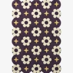 A celestial inspired purple wool rug with scalloped edges, decorated with repeating floral blooms and golden starlight motifs.